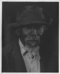 black and white portrait of man in worn hat